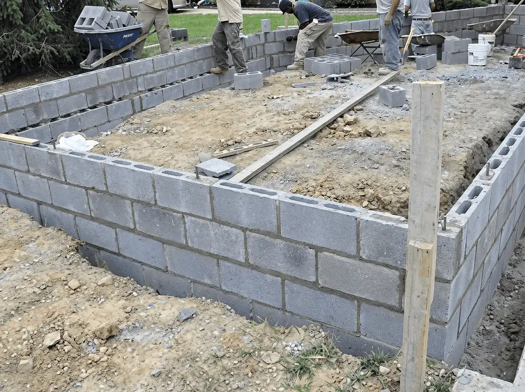 Professionals building a foundation with blocks in Tulsa, OK