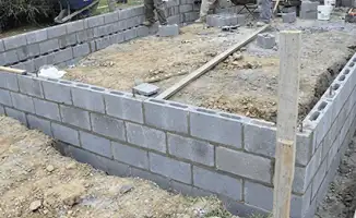 Professionals building a foundation with blocks in Tulsa, OK