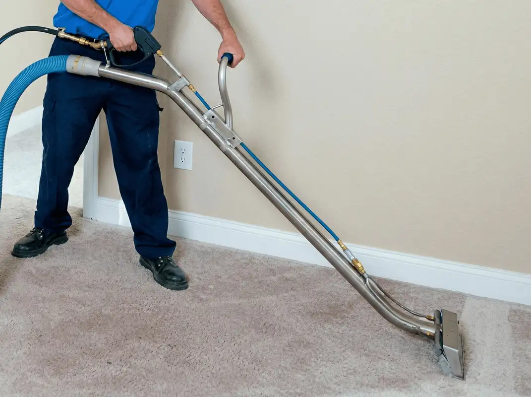 Professional operating a liquid removal machine on a carpeted floor in Tulsa, OK