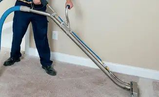 Professional operating a liquid removal machine on a carpeted floor in Tulsa, OK